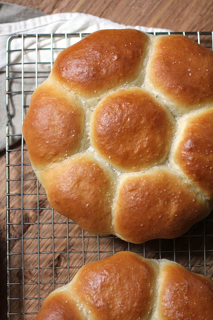 Mom's dinner rolls on a cooling rack over a wood background.