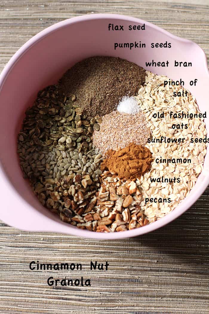 Overhead shot of a pink mixing bowl, with all the dry ingredients portioned out.