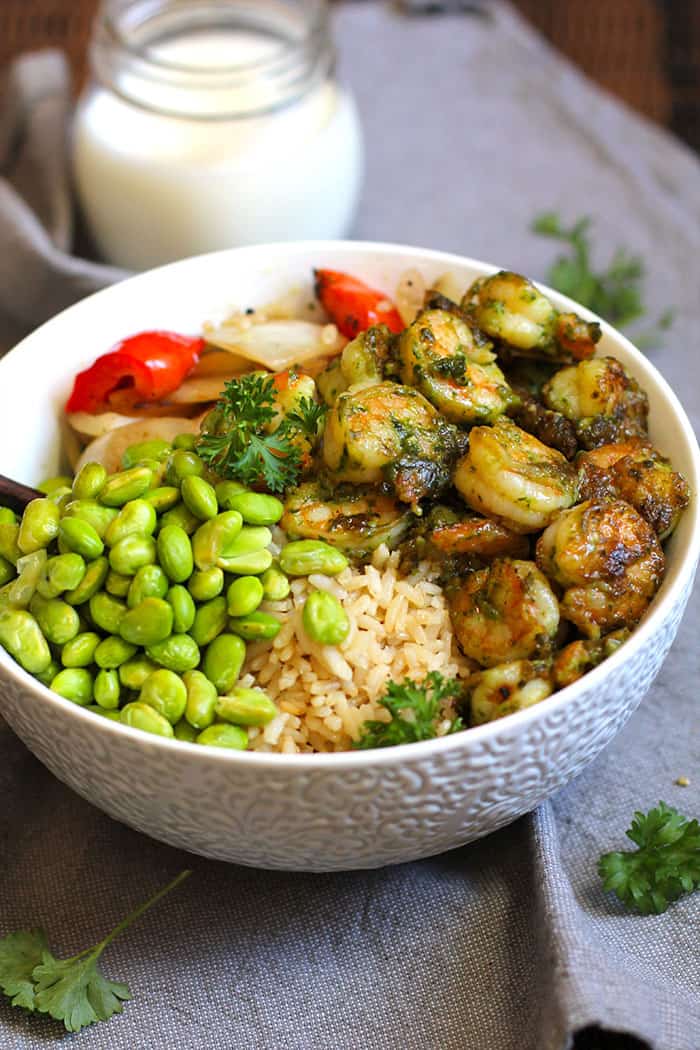 Side shot of the shrimp pesto rice bowl, on a gray napkin.