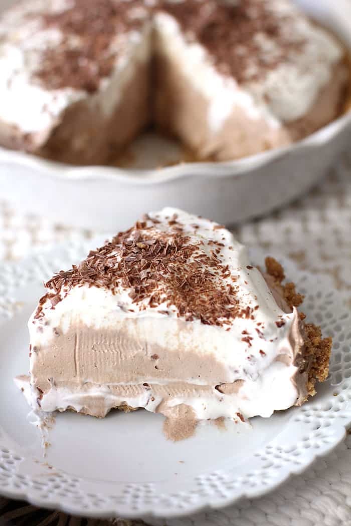 A slice of French silk pie, with more pie in the background.