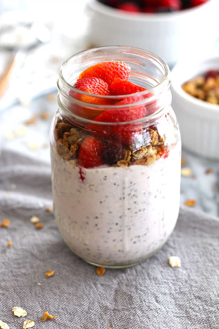 Closeup on a jar of overnight oats with strawberries and granola.