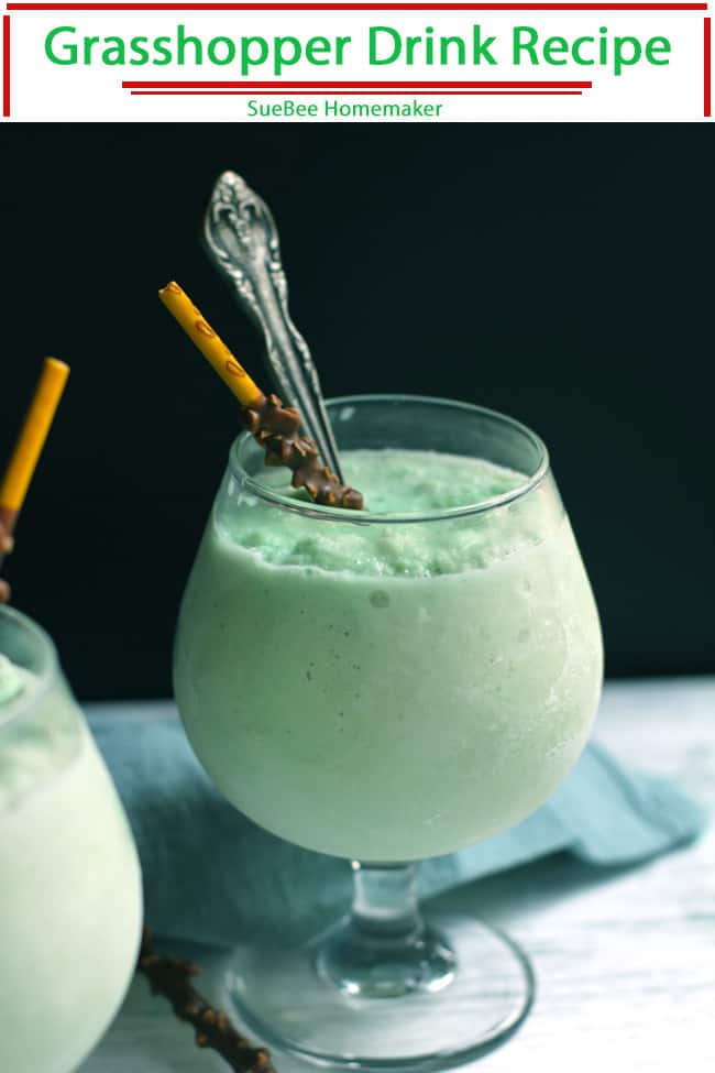 A side view of a frozen grasshopper in a wine glass, with a chocolate stick and a spoon.