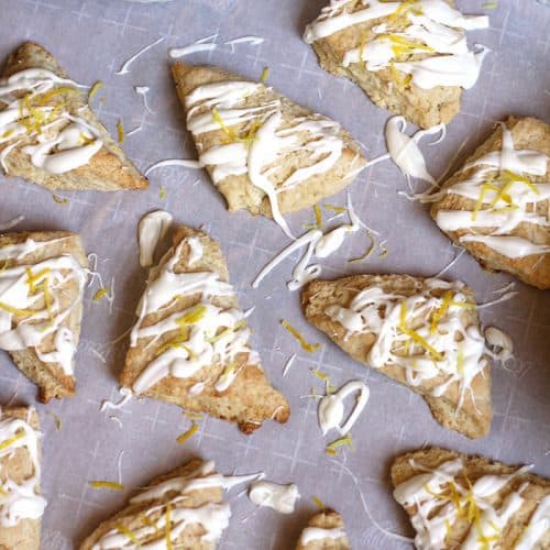 Overhead view of several petite lemons scones, with icing.