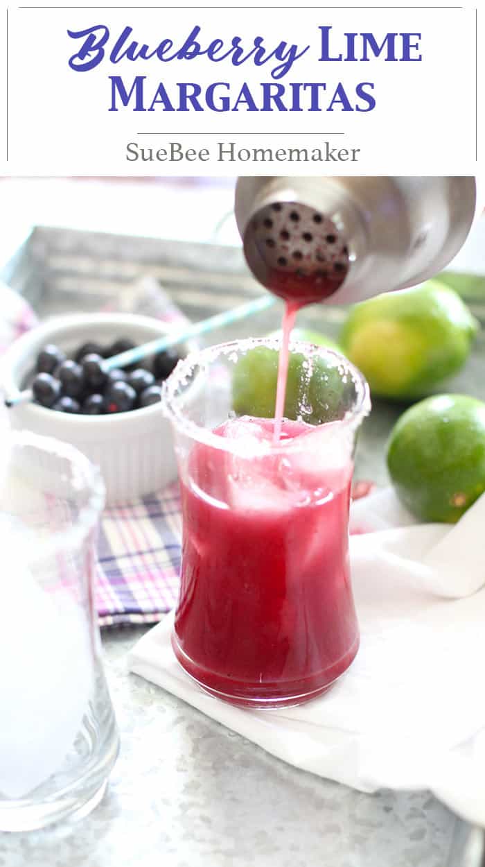 Cocktail shaker filling a glass with blueberry lime margarita.