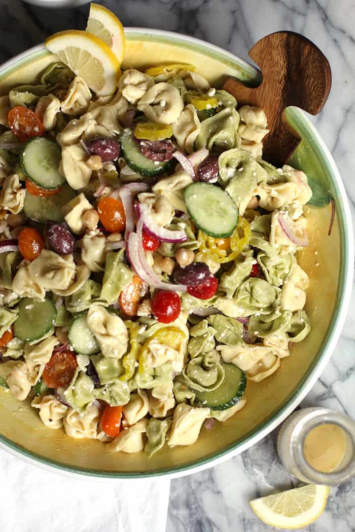 Overhead shot of a large bowl of Greek Tortellini Pasta Salad.