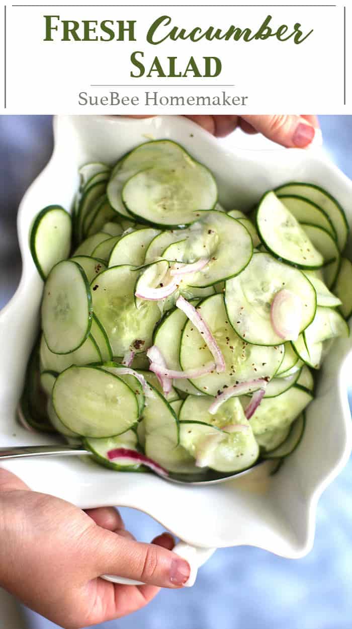 Two hands holding a dish of fresh cucumbers.