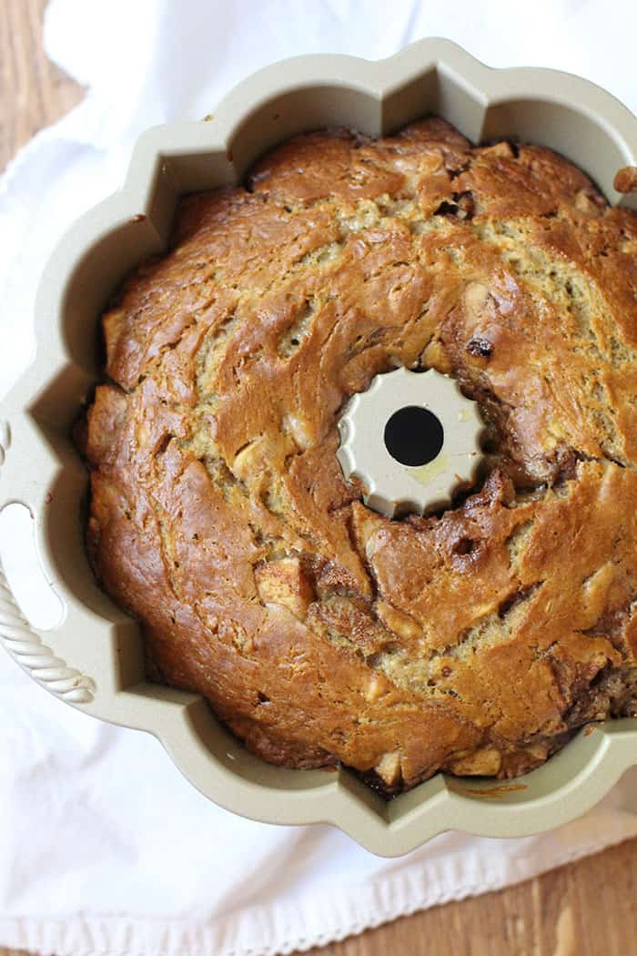 Overhead view of bundt cake in bundt pan, on a white napkin.