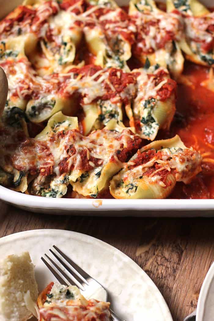 A close up on a partially eaten casserole of turkey sausage stuffed shells.