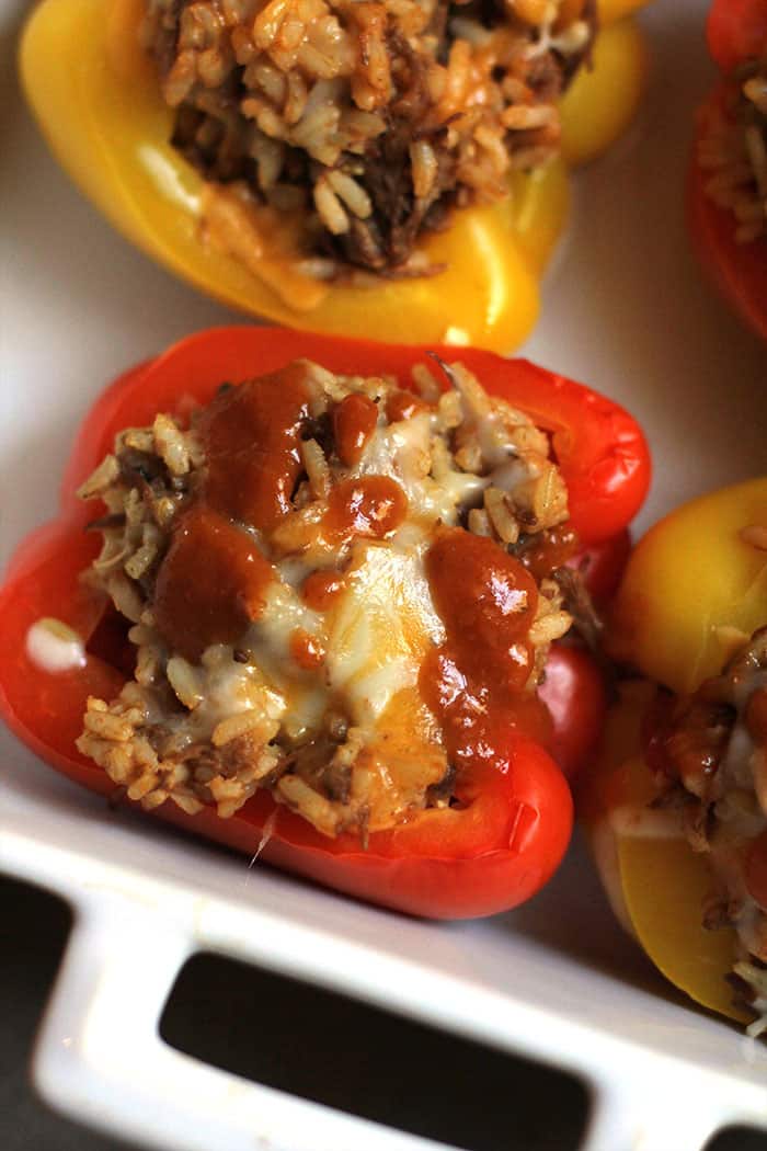 Mexican Beef Stuffed Peppers are not only delicious, but are a colorful "eat with your eyes first" type of food. I love all the flavors in this dish, but you could adapt it to your liking! | suebeehomemaker.com