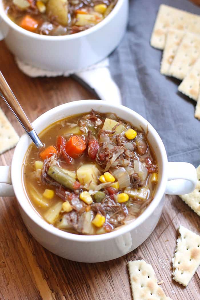 Side shot of two bowls of vegetable beef soup.