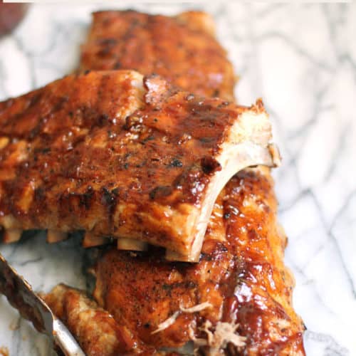 Barbecue Baby Back Ribs are a meat lover's dream. Marinate them overnight, slow roast them in the oven, and then finish them off on the grill for that smokey, barbecue taste! | suebeehomemaker.com