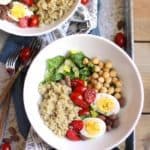 Overhead shot of two bowls of protein packed quinoa salad, on a gray tray.