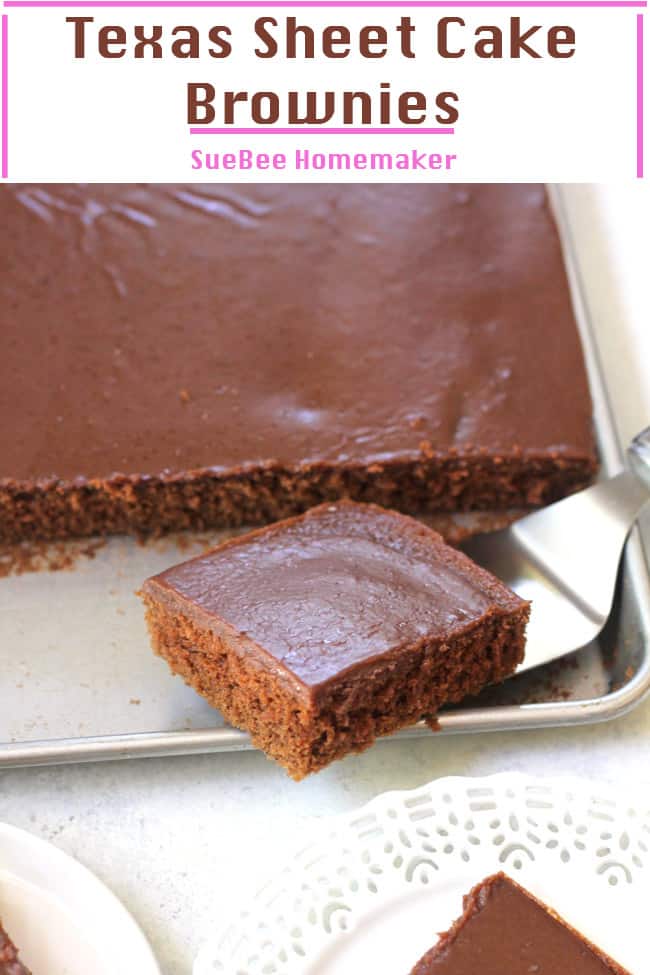 A sheet pan of Texas sheet cake brownies, with one brownie on a serving tool.