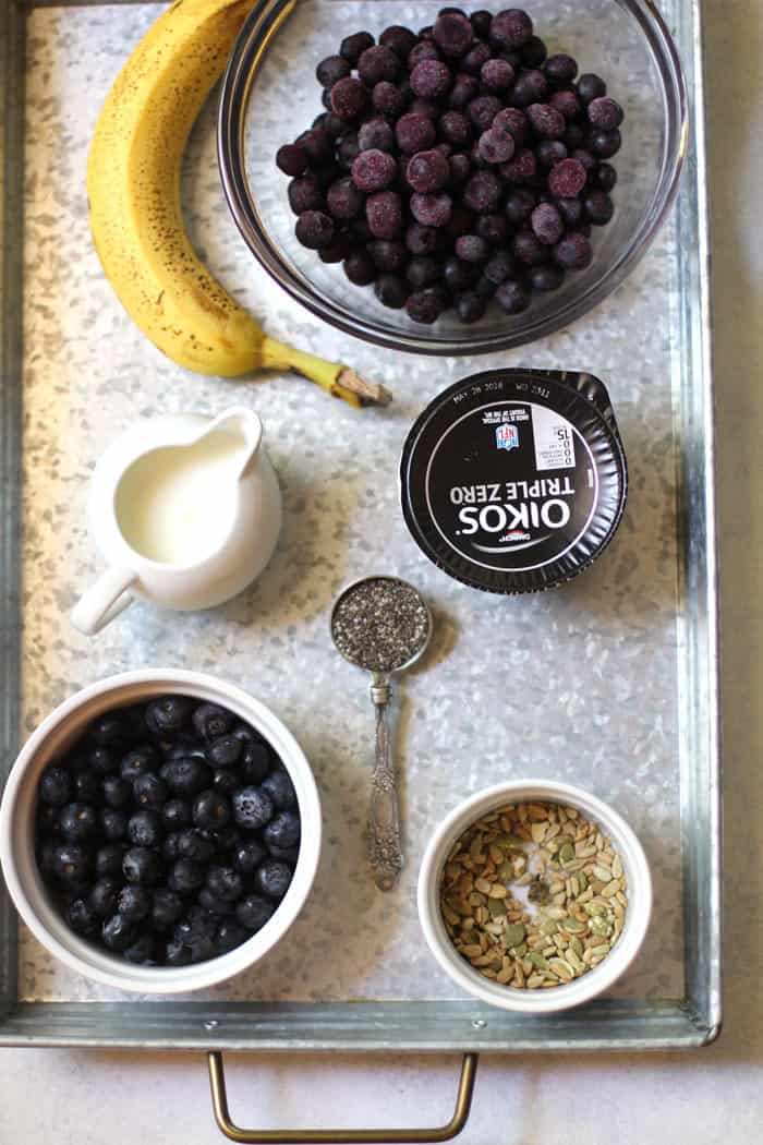 A gray tray of ingredients for smoothie bowls.