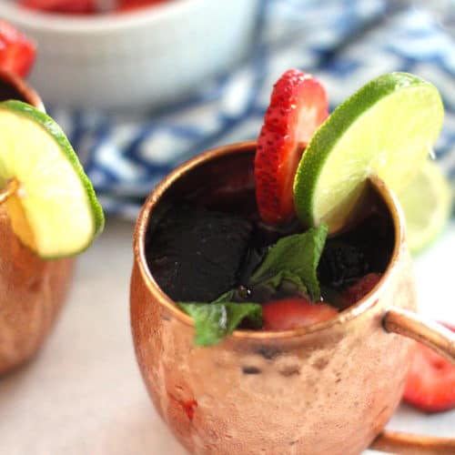 Overhead shot of a Strawberry Mexican Mule, with strawberry and lime slices.