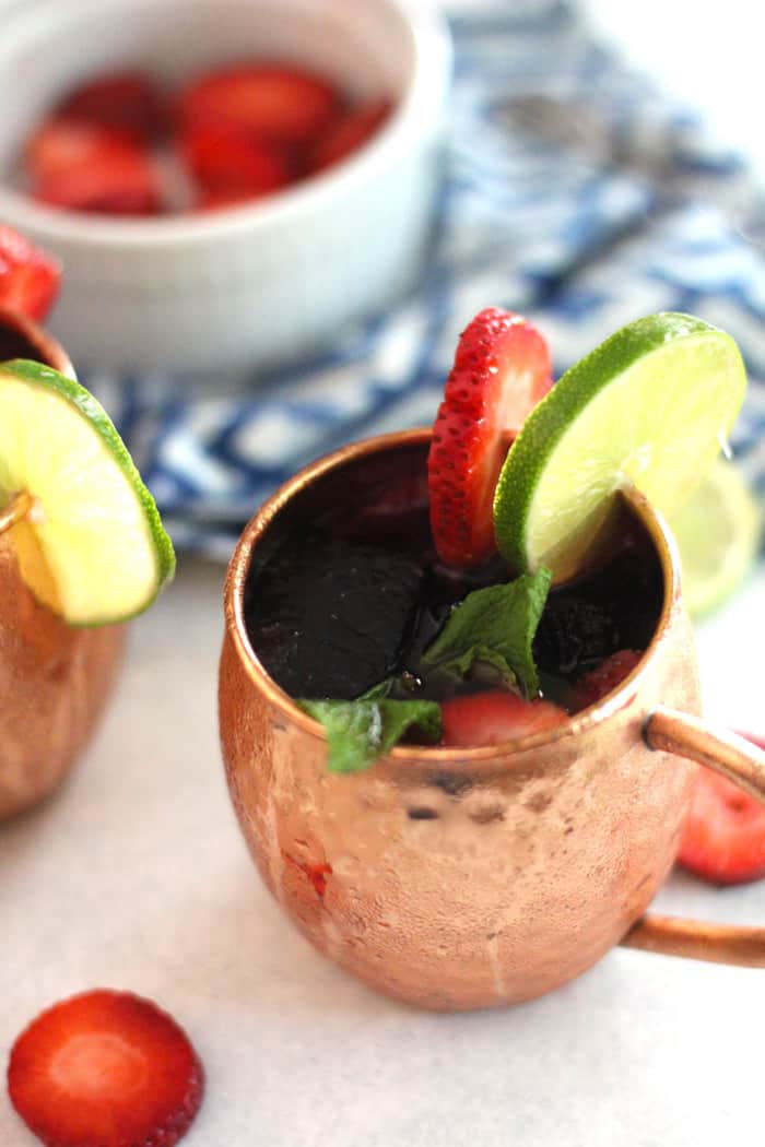 Overhead shot of a Strawberry Mexican Mule, with strawberry and lime slices.