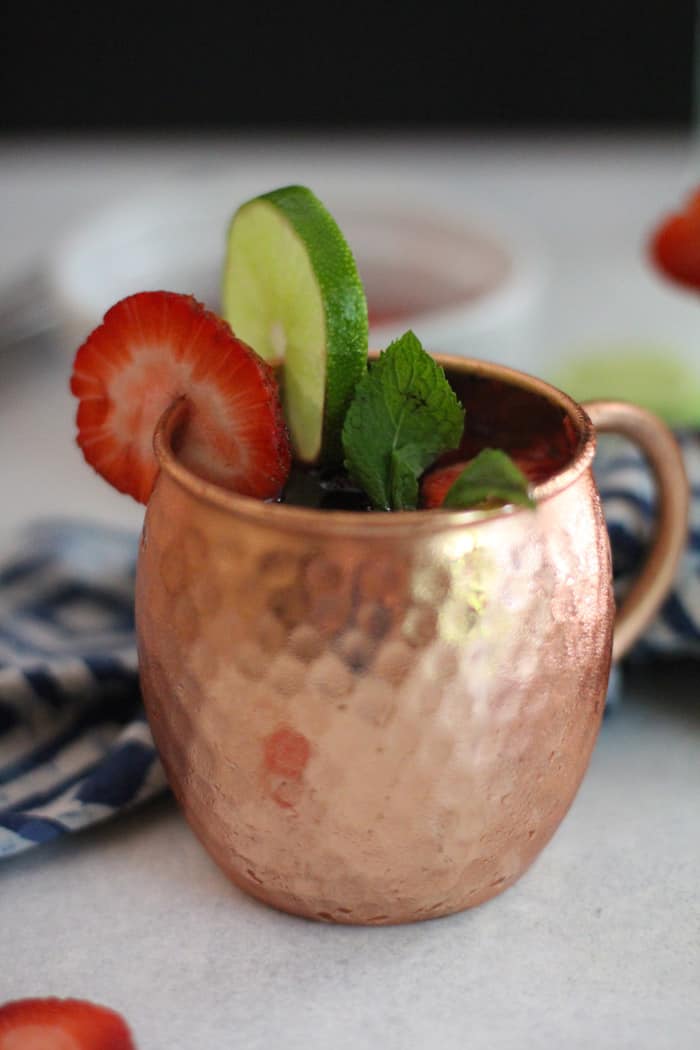 Side shot of a Strawberry Mexican Mule in a copper mug.