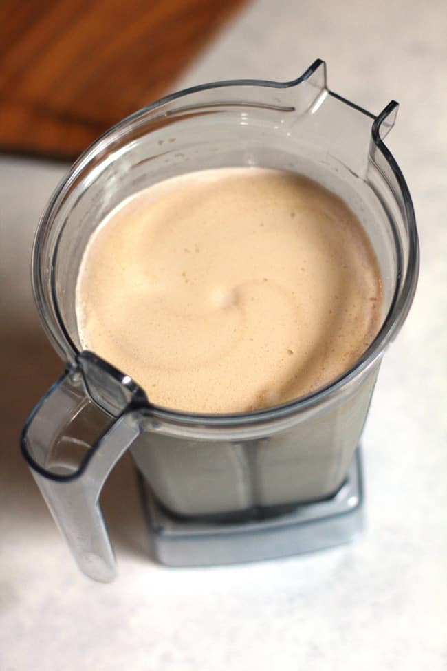 Overhead shot of a pitcher of frozen Kahlua cocktail, on a white background.