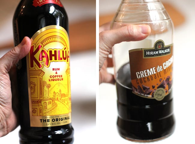 Close-up shots of 1) my hand holding a bottle of Kahlua, and 2) my hand holding a bottle of Creme de Cocoa.