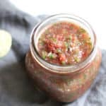 A jar of easy homemade salsa, on a gray napkin.