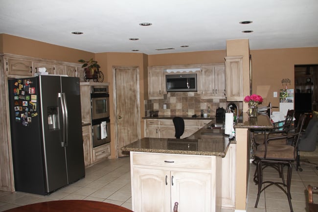 Before picture of our kitchen, with lower ceilings and brown cabinets.