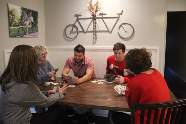 Shot of our kids and girlfriends, plus me, playing cards at the farmhouse table.