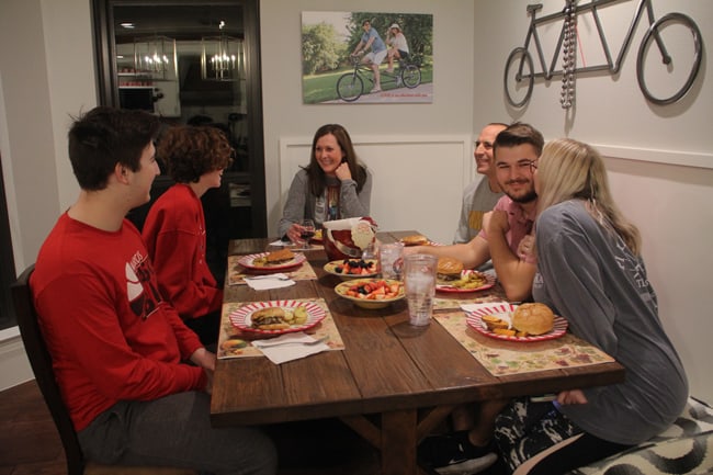 Picture of the family eating dinner at the farmhouse table.