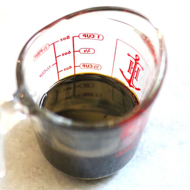 Overhead shot of a measuring cup with molasses.