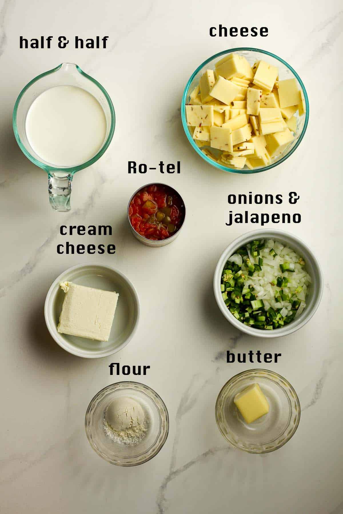 All of the ingredients in bowls on a white background.