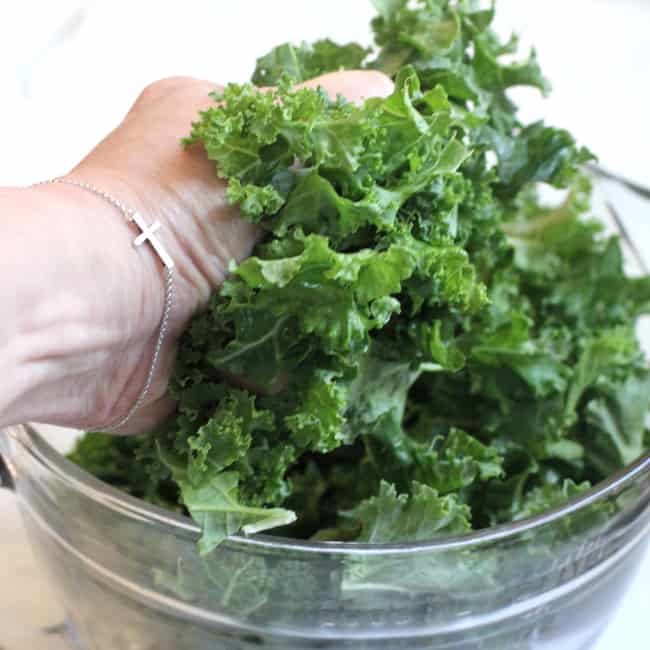 My hand massaging the kale.