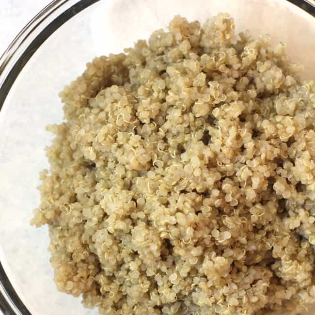 Freshly cooked quinoa in a glass bowl.