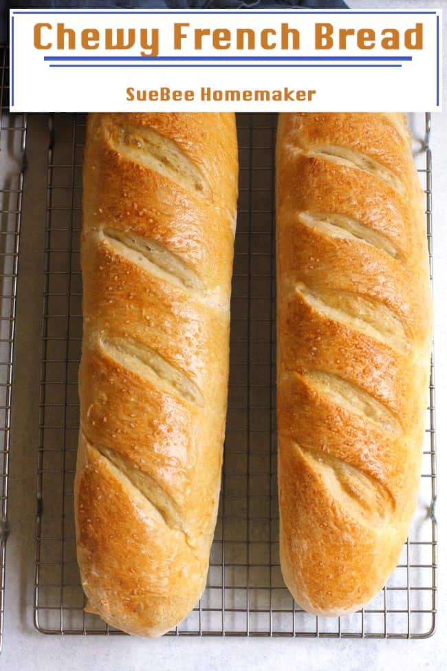 Two loafs of Chewy French bread on a wire cooling rack.