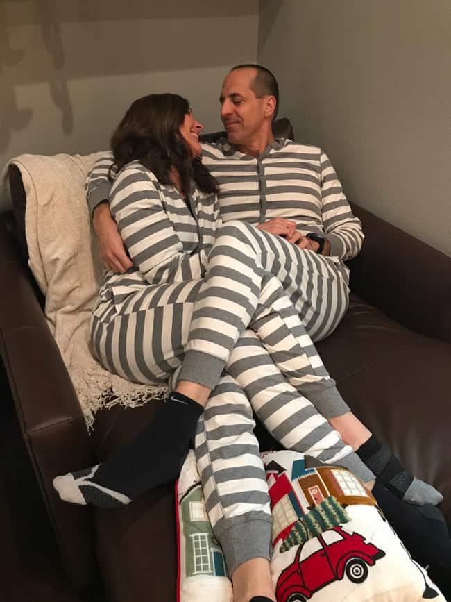 Sue and Mike cuddling in our onesies at Christmas time.