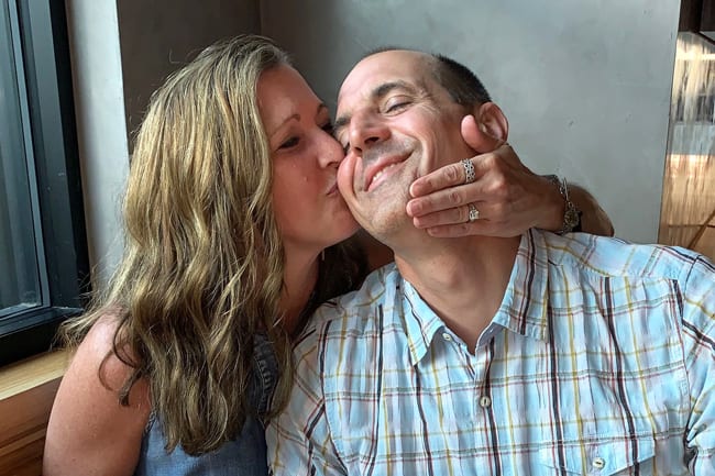 Sue kissing MIke's cheek at a local restaurant.