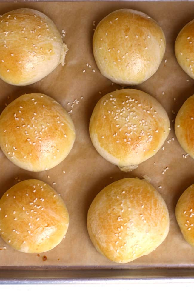 Closeup of six brioche hamburger buns.