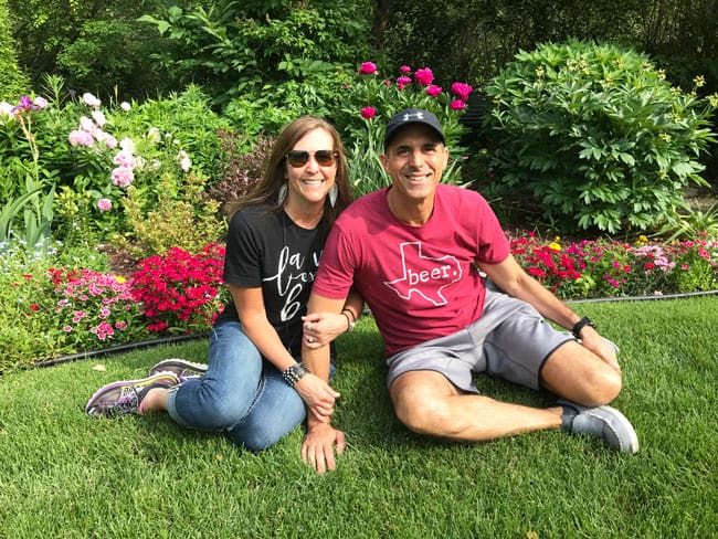 Sue and Mike sitting by flowers in Minnesota.