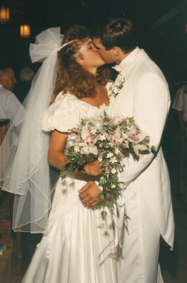 Sue and Mike kissing at the back of church.