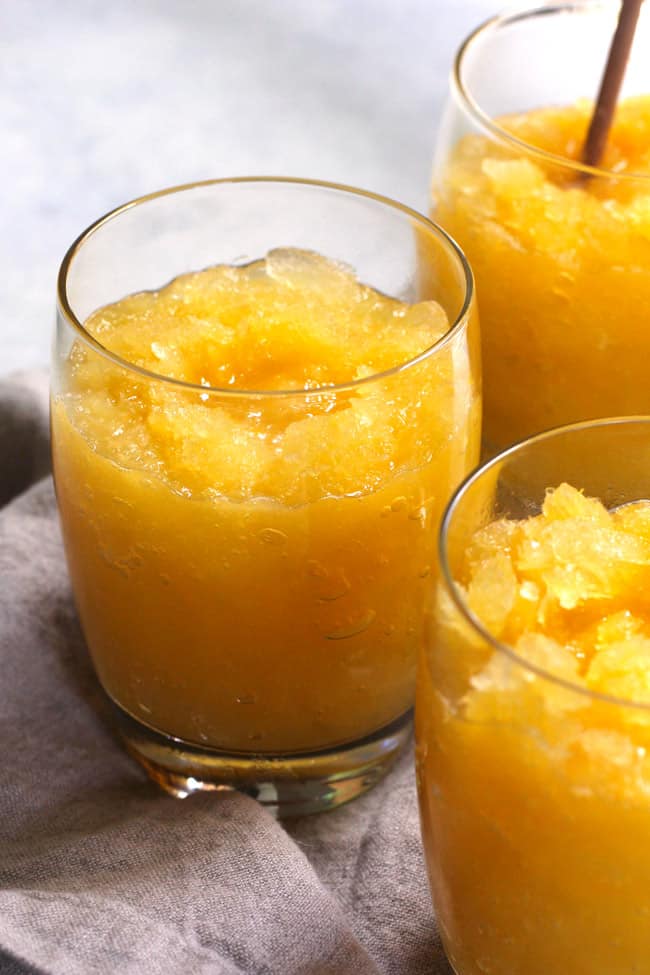 Side view of three glasses of frozen vodka slushes.