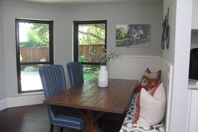 The farmhouse table with seating, and pillows.