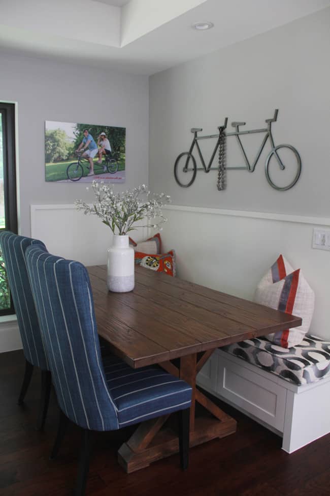 Another angle of the farmhouse table with the iron bike above it.