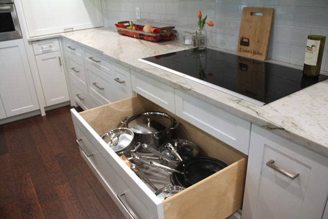 The open drawer showing pots and pans.