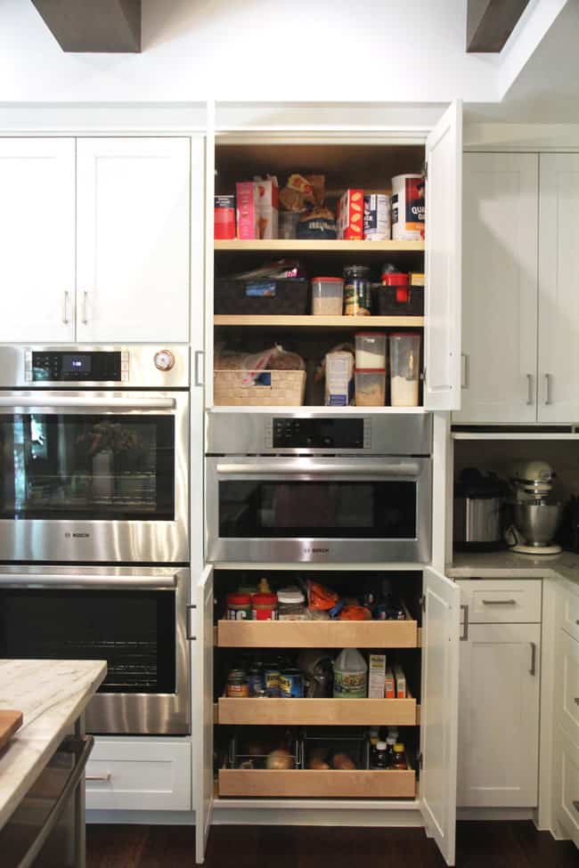 Open pantry over and under microwave.