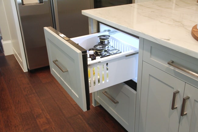 Open refrigerator drawer in island.