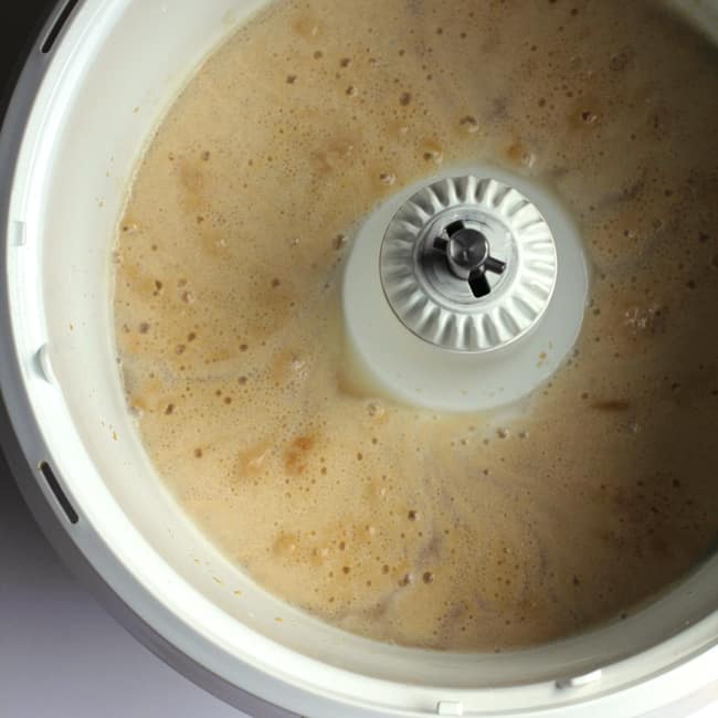 Overhead shot of the Bosch Universal Mixer with the yeast activated and bubbly.
