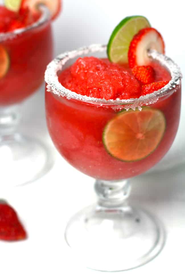 Side shot of two frozen strawberry lemonade margaritas.