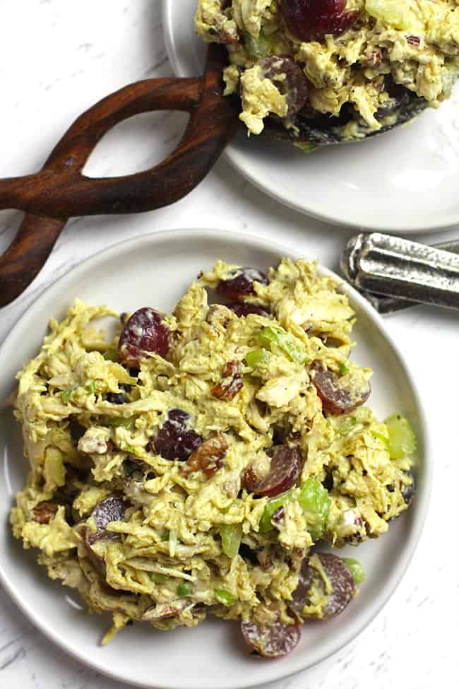 Two serving plates of curry chicken salad.