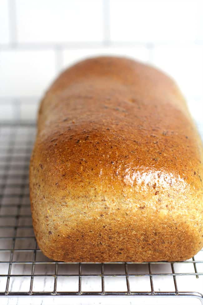 Side shot of a loaf of whole wheat honey bread.