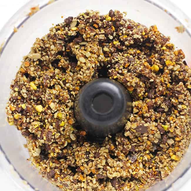 Overhead shot of a food processor filled with processed ingredients for energy bites.