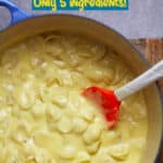 A blue stock pot of creamy Mac and cheese.