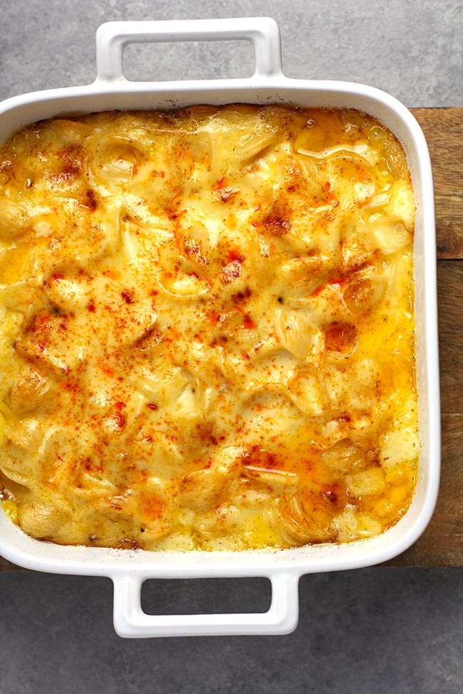 Overhead shot of a square white casserole filled with just baked easy Mac and cheese.